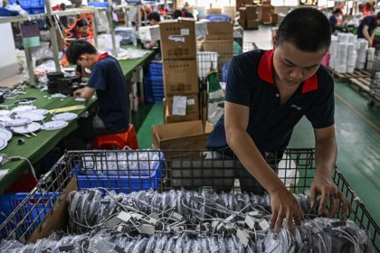Employees work at a factory producing LED lights in Zhongshan, in southern China's Guangdong province on April 17, 2025.
