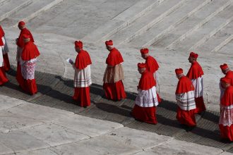 Cardinals walk through St. Peter's Square, as the body of Pope Francis was transferred to St. Peter's Basilica to lie in state.