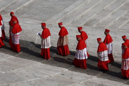Cardinals walk through St. Peter's Square, as the body of Pope Francis was transferred to St. Peter's Basilica to lie in state.