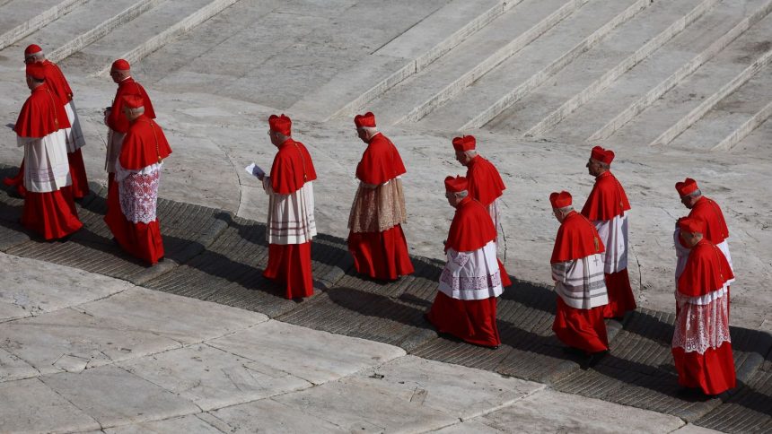 Cardinals walk through St. Peter's Square, as the body of Pope Francis was transferred to St. Peter's Basilica to lie in state.