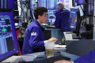 Traders work on the floor of the New York Stock Exchange.