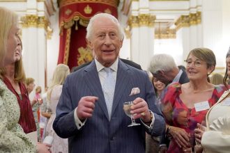 King Charles III speaks to guests during a reception in celebration of community-based initiatives raising awareness about cancer and supporting those living with cancer at Buckingham Palace on April 30, 2025 in London, England.