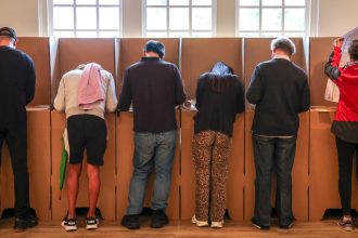 Voters mark their ballot papers at a pre-polling center in Sydney on May 2, ahead of Australia's federal election scheduled for May 3.