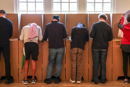 Voters mark their ballot papers at a pre-polling center in Sydney on May 2, ahead of Australia's federal election scheduled for May 3.