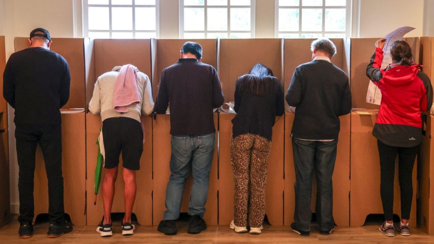 Voters mark their ballot papers at a pre-polling center in Sydney on May 2, ahead of Australia's federal election scheduled for May 3.