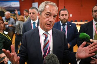 Reform UK leader Nigel Farage speaks with the press as he celebrates the victory of Sarah Pochin.