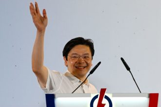 Singapore Prime Minister Lawrence Wong of the People's Action Party (PAP) celebrates at the party's gathering centre.