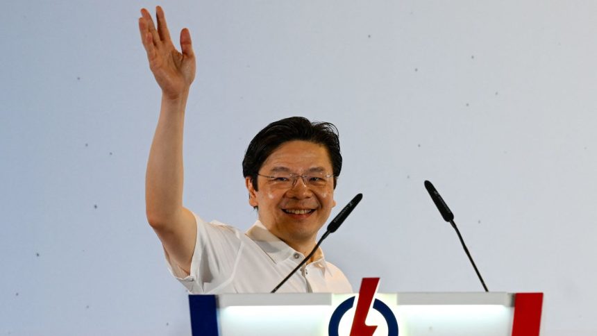 Singapore Prime Minister Lawrence Wong of the People's Action Party (PAP) celebrates at the party's gathering centre.
