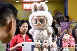 People look at Labubu collectable toys at a Pop Mart pop-up store in Siam Center shopping mall in Bangkok on May 6, 2025.