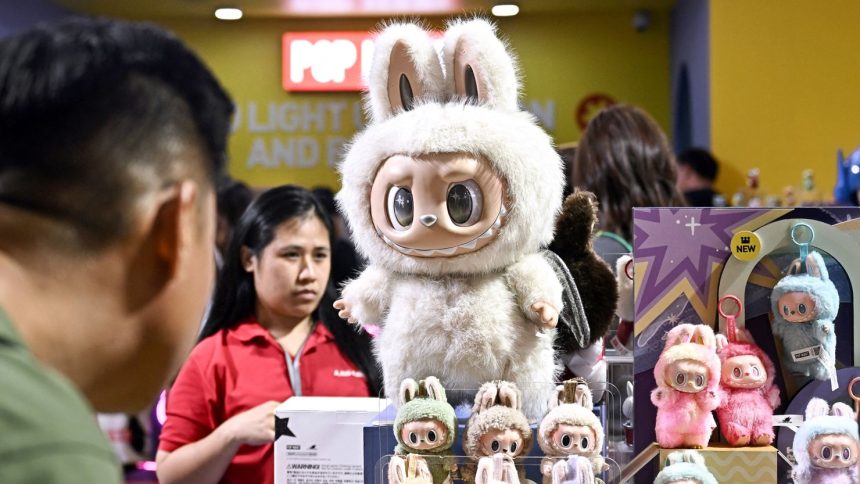 People look at Labubu collectable toys at a Pop Mart pop-up store in Siam Center shopping mall in Bangkok on May 6, 2025.