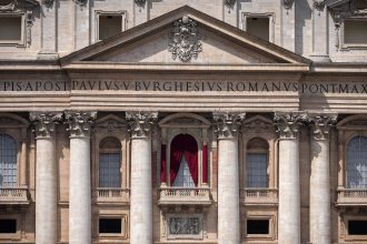 Red drapes are installed Monday on the main balcony of St. Peter's Basilica, where the new pope will be introduced to the world.