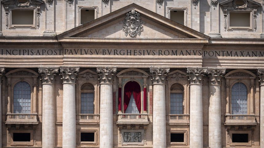 Red drapes are installed Monday on the main balcony of St. Peter's Basilica, where the new pope will be introduced to the world.