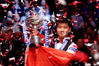 Zhao Xintong holds the Halo World Snooker Championship trophy at the Crucible Theatre on May 5, 2025 in Sheffield, England.