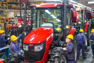 Employees work on the tractor assembly line at a YTO Group Corporation factory in Luoyang, Henan province, China, on May 6.