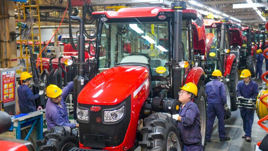 Employees work on the tractor assembly line at a YTO Group Corporation factory in Luoyang, Henan province, China, on May 6.