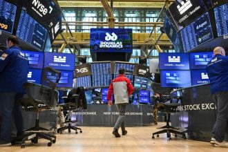 Traders work on the floor of the New York Stock Exchange.