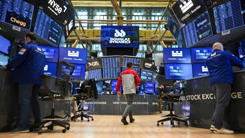 Traders work on the floor of the New York Stock Exchange.