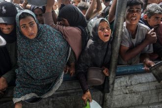 Charitable organizations distribute hot meals to Palestinians in the Al-Mawasi area of Khan Yunis, Gaza on May 12.