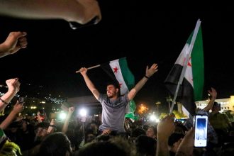 People celebrate in Umayyad Square in Damascus, Syria, on May 13, following US President Donald Trump's decision to lift sanctions in Syria.