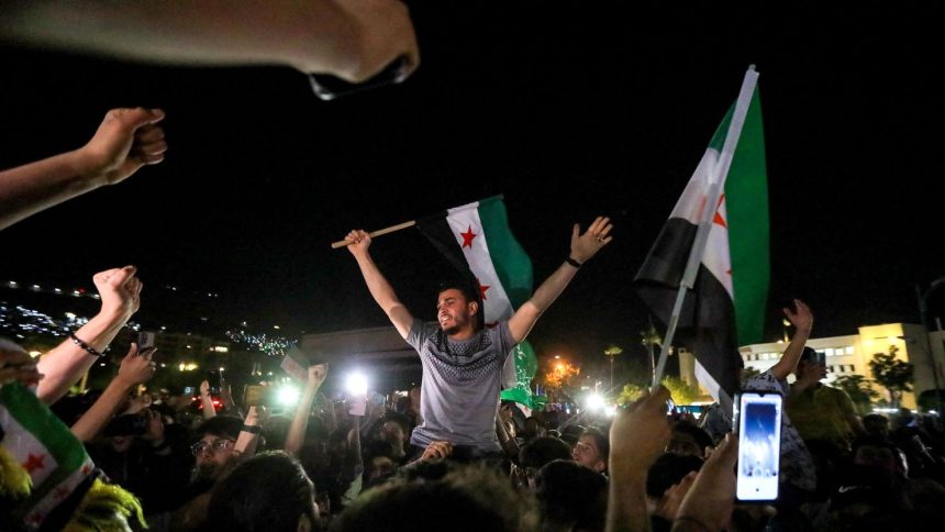 People celebrate in Umayyad Square in Damascus, Syria, on May 13, following US President Donald Trump's decision to lift sanctions in Syria.