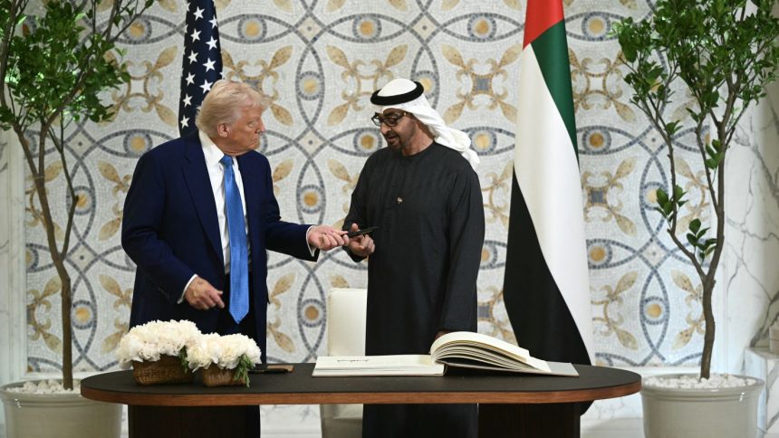 US President Donald Trump returns the pen to his UAE counterpart Sheikh Mohamed bin Zayed Al Nahyan, after signing the guest book at Qasr Al-Watan in Abu Dhabi on Thursday.