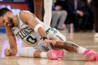 Jayson Tatum of the Boston Celtics lays on the ground after being injured against the New York Knicks during the fourth quarter on Monday.