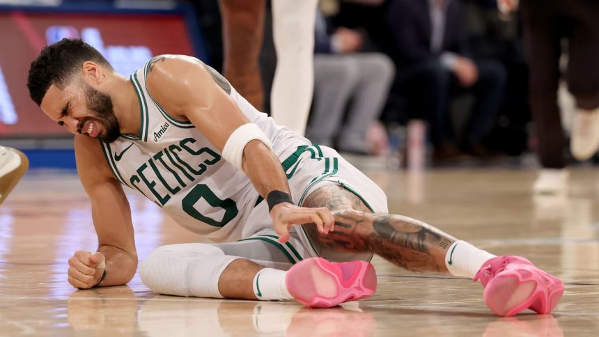 Jayson Tatum of the Boston Celtics lays on the ground after being injured against the New York Knicks during the fourth quarter on Monday.