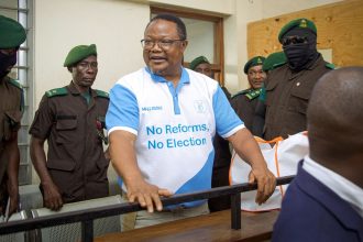 Tanzania's main opposition leader Tundu Lissu, center, stands in the dock at Kisutu magistrate's court in Dar es Salaam on May 19, 2025.