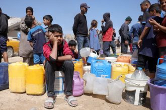Palestinians attempt to collect water at a camp for displaced people in Gaza City, on May 20, 2025 amid Israel's military operation in the enclave.