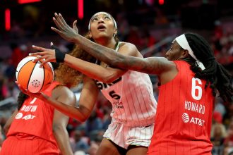 Angel Reese (center) had 12 points and 17 rebounds in the Chicago Sky's loss to the Indiana Fever on Saturday.