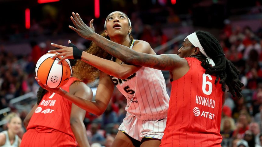 Angel Reese (center) had 12 points and 17 rebounds in the Chicago Sky's loss to the Indiana Fever on Saturday.