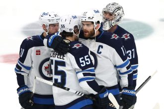 Mark Scheifele and Adam Lowry  hug after their defeat.