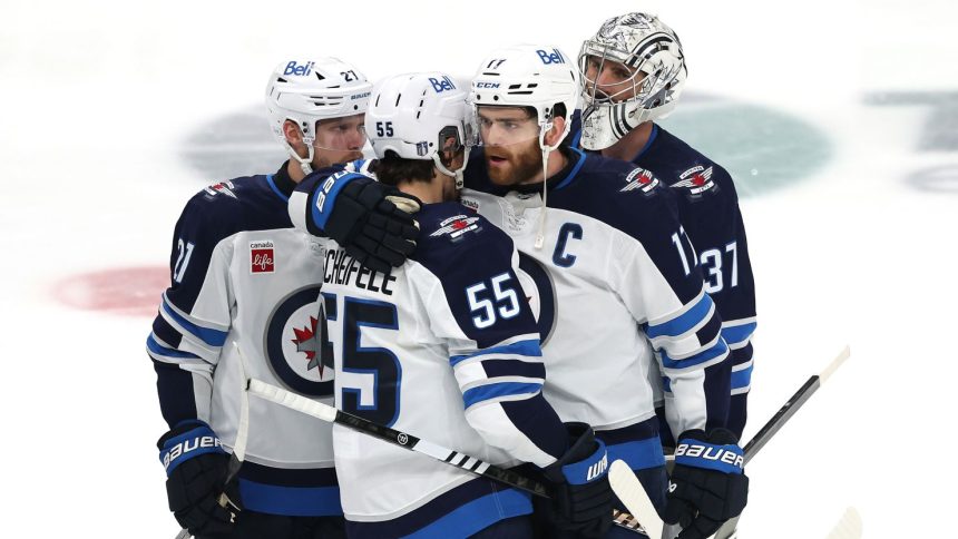 Mark Scheifele and Adam Lowry  hug after their defeat.
