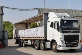 A truck carrying humanitarian aid drives through the Kerem Shalom crossing between southern Israel and the Gaza Strip, on May 22, 2025. The UN said on May 21 it had "dispatched" around 90 trucks carrying aid into Gaza.
