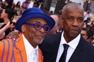 Spike Lee and Denzel Washington attend the "Highest 2 Lowest" red carpet at the 78th annual Cannes Film Festival at Palais des Festivals on May 19, 2025 in Cannes, France.