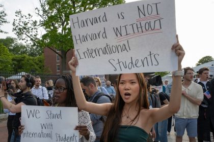 People hold signs during the Harvard Students for Freedom rally in support of international students at the Harvard University campus in Boston, Massachusetts, on Tuesday.
