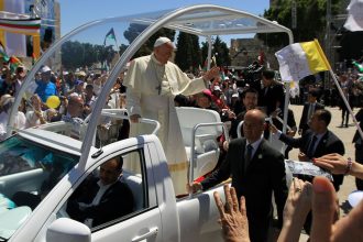 Pope Francis waves to the crowd, from his popemobile, as he arrives at the Manger Square for an open-air mass on May 25, 2014, outside the Church of the Nativity in Bethlehem, in the occupied West Bank.