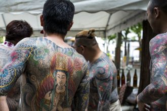 Heavily tattooed yakuza members seen at the Sanja Matsuri Festival in Tokyo's Asakusa district on May 14, 2016.