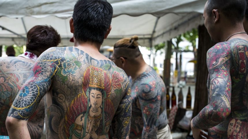 Heavily tattooed yakuza members seen at the Sanja Matsuri Festival in Tokyo's Asakusa district on May 14, 2016.