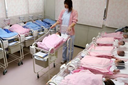 Hospital staff attend to babies in the nursery ward in Misato city, Saitama prefecture, Japan.