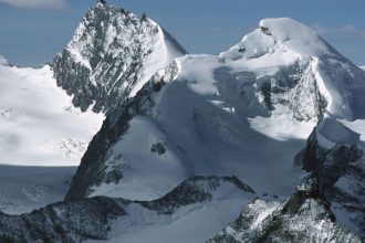 The snow-capped peaks of Rimpfischhorn (left) and Allalinhorn in the Valais Alps, Switzerland.