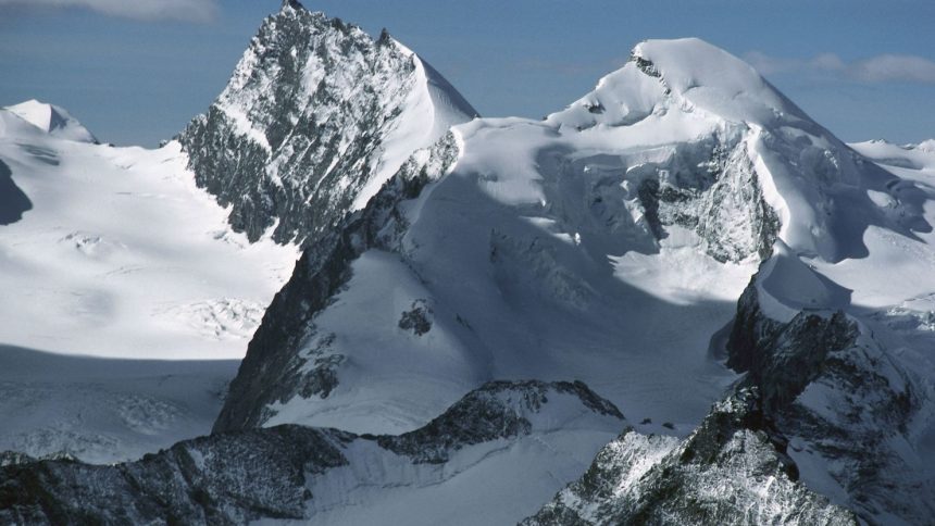 The snow-capped peaks of Rimpfischhorn (left) and Allalinhorn in the Valais Alps, Switzerland.