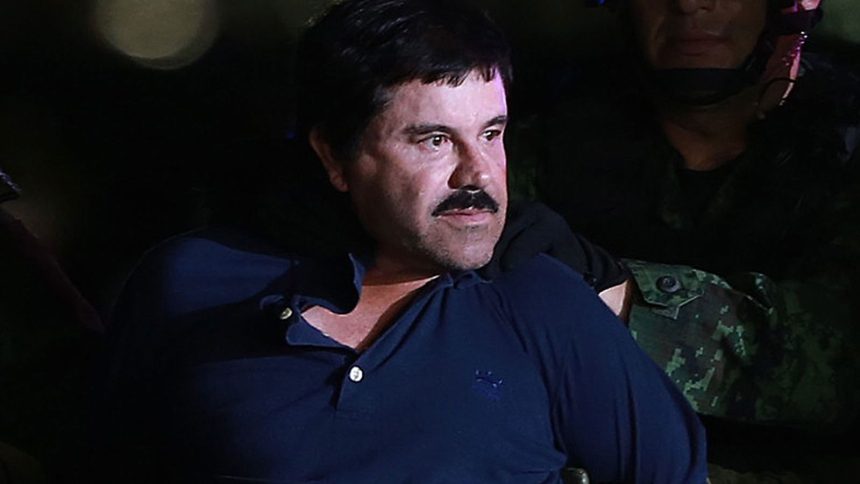 Cartel boss Joaquin Guzman is escorted by Mexican security forces at a Navy hangar in Mexico City, Mexico, on Jan. 8, 2016.