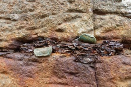 Coins in a crevice between two stones at Giant's Causeway