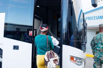 A woman being returned to Haiti boards a bus in the Dominican Republic.