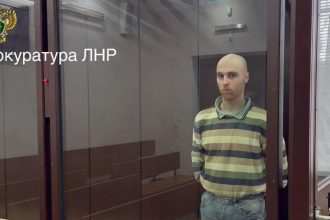 Oscar Jenkins, an Australian man sentenced to 13 years in prison for fighting alongside Ukrainian forces against Russia, appears in a courtroom in Russian-controlled Luhansk, in eastern Ukraine, on Friday, May 16, 2025.