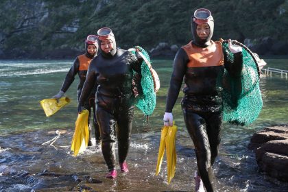 A group of Haenyeo (women divers) walk on the beach after diving on Jeju Island, South Korea, November 19, 2023.