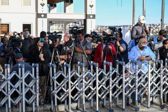 Members of the media gather outside the presidential office in Istanbul on Thursday.