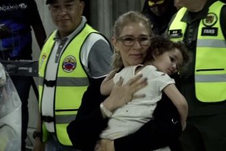 First lady of Venezuela, Cilia Flores, carries Maikelys Antonella Espinoza Bernal upon her return to Venezuela at Simon Bolivar International Airport on May 14, 2025.