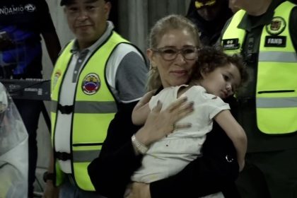 First lady of Venezuela, Cilia Flores, carries Maikelys Antonella Espinoza Bernal upon her return to Venezuela at Simon Bolivar International Airport on May 14, 2025.